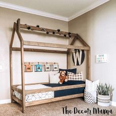 a bedroom with a bed frame made out of wooden planks and a teddy bear