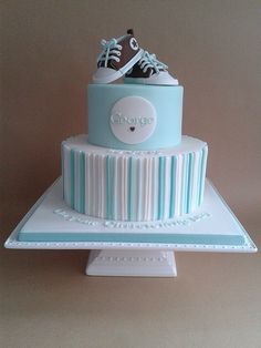 a blue and white cake with shoes on top