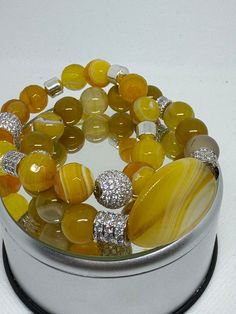 Double strand yellow agate bracelet set with center focal bead. This one has silver bling. Yellow Agate, Bracelets Patterns, Silver Bling, Diy Bracelets Patterns, Pompano Beach, Agate Bracelet, Strand Bracelet, Focal Bead, Jewelry Lover