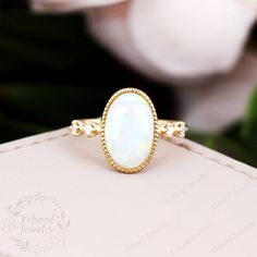 "Please confirm your US size when you make an order) Jewelry Details -Gold Type: Solid 10K Gold / Solid 14K Gold / Solid 18K Gold (Choose One in Material Option) Center Stone: Lab Created Opal 8*12mm, Approximately 2.58ct Shape: Oval Shape Side Stones: Moissanite Moissanite Total Carat Weight: approx. 0.08ctw Color: D-F Clarity: VVS1 Band Width: Approximately 1.5mm SKU: YR0819 ~*-*~Purchase Guarantee: - All our jewelry is handmade, and each process is refined. - 14 Day Refund Guarantee. - All ou Oval White Opal Ring In 14k Gold, White Oval Opal Ring In 14k Gold, White Opal Ring Stamped 14k For Gift, White Opal Ring Stamped 14k As Gift, 14k Gold Oval White Ring, White Oval Solitaire Birthstone Ring, White Opal Ring With Accent Stones In 14k Gold, Oval White Moonstone Ring In 14k Gold, Oval White 14k Gold Ring