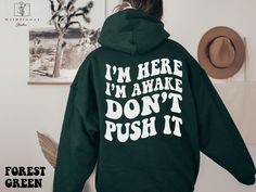 I'm Here I'm Awake Don't Push It Hoodie,  Hoodie with Words On Back, Aesthetic Hoodie,  Trendy hoodie, hoodies for women, funny hoodie,  If you are looking for soft and cozy hoodie, you're in the right place! Our unisex hoodies are heavy blend hooded sweatshirt. The material is a thick blend of cotton and polyester. This makes for a plush, soft feel alongside warmth. It's also a great surface for printing. There are no side seams.  A spacious kangaroo pocket hangs in front. The hood's drawstring This Is My Idc Hoodie, Nope I'm Going Back To Bed Hoodie, Funny Sweatshirts Hoodie Cricut, Back Aesthetic, Sarcastic Clothing, It Hoodie, Aesthetic Hoodie, Hoodies For Women, Push It