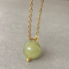 "UNIQUE GREEN JADE CRSYTAL CHAIN NECKLACE This necklace features a dainty, natural gemstone threaded on a 14k Gold Filled, Stainless Steel chain. Available in color options, this necklace is ideal for layering & makes the perfect gift! Please visit our store for other color options! Jade is believed to bring luck. Just like a four-leaf clover is considered a symbol of good fortune, jade is thought to have protective, lucky-charm energy.   ☆ Each of the stones we use to create necklaces were formed by nature over years. Each one is unique and beautiful just like nature itself.  We do not process or change our stones in any way, we accept their \"unique and raw\" beauties. We don't polish away \"flaws\" in the stones but rather leave them in their natural state.  Just like people, each stone Jade Round Pendant Necklace For Healing, Elegant Jade Crystal Necklace For Gift, Elegant Jade Crystal Necklace As Gift, Jade Pendant Necklaces For Crafting, Round Beads Natural Stones Charm Necklace As Gift, Natural Stones Round Bead Charm Necklace As Gift, Jade Gemstone Round Pendant Necklace, Green Natural Stones Round Necklace, Green Natural Stones Necklace