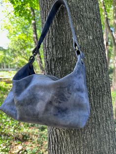 This modern hobo bag is high on function and style. Lightweight and easy to carry, you will be using for this bag for every day, and yet it's stylish enough for a casual evening out. You will be surprised how much you can carry in this smaller sized bag! Leather: This was a specialty hide. It as a charcoal grey base color with a black marbling affect. Size: Approx. 12 inches wide x 9 inches tall with a 5 1/2 inch bottom gusset. Closure: Zippered with leather tassel Hardware: Antique Brass Straps Hobo Style, Casual Evening, Marbling, Leather Tassel, Hobo Bag, Base Colour, Charcoal Grey, Antique Brass, Every Day