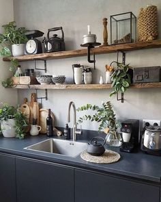 a kitchen with shelves filled with pots, pans and other items on the wall