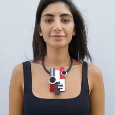 A unique statement necklace for women made from plexiglass, resin and acrylic colors and black crystals. This red necklace is lightweight and will upgrade any elegant outfit. Share with the world your exquisite taste! *   *   *   *   *   *   *   *   *   *   * Materials: 0.12/3mm thick plexiglass 0.12"/3mm thick acrylic mirror 0.31"/8mm thick black silicone cord Resin Black crystals Gold plated elements - 1.5 micron shiny finish Measurements: Central element width: 2.35"/6 cm Central element height: 4.35"/11 cm Maximum tickness: 0.6"/1.5 cm *   *   *   *   *   *   *   *   *   *   * For more jewelry from this collection click on the liink: https://www.etsy.com/shop/GilPashutDesigns?ref=seller-platform-mcnav§ion_id=32100580 *   *   *   *   *   *   *   *   *   *   * Care tips: I use only high Modern Red Necklace For Party, Chic Red Necklace For Party, Bold Black Necklace For Gift, Bold Black Necklace For Gifts, Bold Black Jewelry For Gifts, Bold Black Jewelry For Gift, Bold Black Jewelry Gift, Unique Statement Necklace, Red Necklace