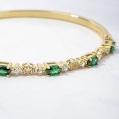 "This stunning emerald and cz bangle bracelet is super trendy and stylish! It's comfortable and lightweight. Looks great stacked or on its own!  - - - D E T A I L S - - - * We use a THICK plating of 14k Gold or Rhodium over 925 Sterling Silver  * Super high-quality & lightweight * Available in 6.25\", 6.75\" or 7\" * Latch Closure * 3mm thick  * Nickel-free & Hypoallergenic  BANGLES ON MODEL----> SOLID BANGLE https://www.etsy.com/listing/1553953045/bangle-bracelet-by-sami-jewels?click_key=f0f5ce3a5a09309ef8860b089ac71977a9c6f94f%3A1553953045&click_sum=b22f030f&ga_search_query=bangle&ref=shop_items_search_1&pro=1&frs=1&sts=1 DIAMOND STUDDED BANGLE: https://www.etsy.com/listing/1553953045/bangle-bracelet-by-sami-jewels Made with 100% Pure Love! ♡ Happy to answer any questions you may have! ? Gold Bracelet Bangle, Bracelet Emerald, Emerald Bracelet, Bracelet Minimalist, Bridesmaid Gifts Jewelry, Bracelet Dainty, Dainty Bracelet, Vintage Bracelet, Minimalist Bracelet