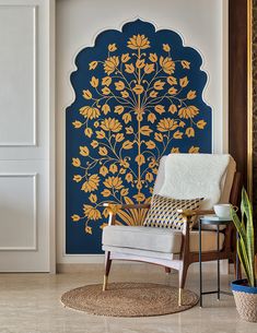 the room is decorated with blue and yellow wallpaper, including an intricate tree mural