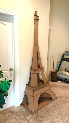 a cardboard model of the eiffel tower is sitting in front of a door