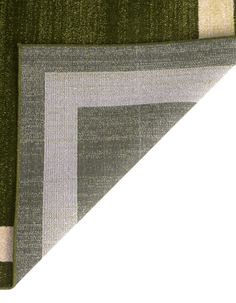 a close up of a green rug with white and grey squares on it's side