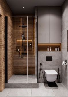 a bathroom with a toilet, sink and shower in it's center wall next to a walk - in shower