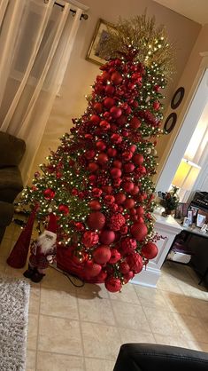 a christmas tree decorated with red and gold ornaments