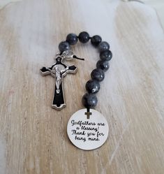 "\"Godfathers are a blessing, thank you for being mine\" This handmade rosary is the perfect gift for a godparent. I made this rosary using 10mm smooth round black labradorite. The beads are hand knotted using nylon thread. The cross is silver tone and black enamel, stunning quality  The charm is stainless steel with a unique cross cutout and the words are laser engraved.  This rosary will arrive in a pouch ready to be gifted" Godfather Proposal, Cross Cutout, Best Gif, Black Labradorite, God Parents, Proposal Gifts, Rosary Beads, Catholic Gifts, Baptism Gifts