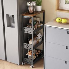 a kitchen area with a refrigerator, counter top and shelves filled with food on wheels