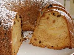 a cake that has been cut in half and is sitting on a plate with powdered sugar