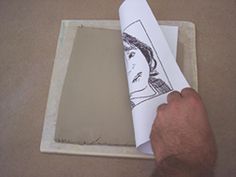 a person is holding a piece of paper with a drawing on it