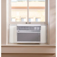 an air conditioner sitting on top of a window sill