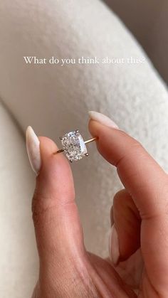 a woman's hand holding an engagement ring with the words what do you think about this?