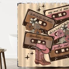 a shower curtain with three cassettes and flowers on them, one is brown and the other is pink