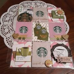 a table topped with lots of different types of cards and paper crafts on top of a doily