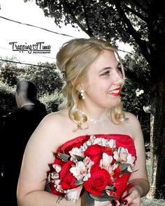 a woman in a red dress holding a bouquet