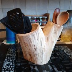 wooden utensils and spoons in a holder on a kitchen counter