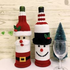 two wine bottles decorated like santa claus and a snowman are sitting next to each other