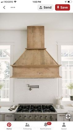 a stove top oven sitting inside of a kitchen next to a wall mounted range hood