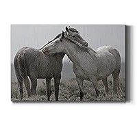 two horses that are standing next to each other