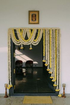 an entrance decorated with yellow and white garlands