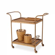 a gold serving cart with two baskets on it and one basket sitting on top of the cart