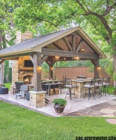 an outdoor kitchen and grill area in the backyard