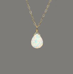 "Opal necklace, fire opal drop necklace, sparkly gem necklace, opal teardrop necklace, dainty 14k gold filled chain A super flashy opal drop is wire wrapped onto a 14k gold filled chain or sterling silver chain in the length of your choice! The teardrop measures 10mm x 8mm. More from BubuRuby? https://www.etsy.com/shop/BubuRuby?ref=hdr_shop_menu Looking for other charm necklaces? https://www.etsy.com/shop/BubuRuby?section_id=12318467 Raw crystal necklaces? https://www.etsy.com/shop/BubuRuby?sect Dainty Teardrop Wire Wrapped Necklace, Dainty Wire Wrapped Teardrop Necklace, Gold Teardrop Opal Necklace, Dainty Teardrop Opal Necklace, Handmade Opal Teardrop Necklace, Gold Opal Teardrop Necklace, White 14k Gold Filled Teardrop Necklace, Minimalist Teardrop Opal Jewelry, Gift Teardrop 14k Gold Filled Drop Necklace