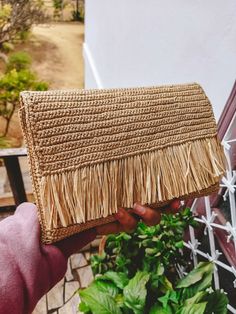 Boho chic style natural raffia clutch with fringe, wedding clutch. The ideal accessory for summer, can be worn during the day or in the evening. Both in town and at the beach. Dimensions: 25 x 16 cm Color Natural With a closure and interior lining Manufacturing: Made in Madagascar Chic Straw Bag With Fringe, Chic Rectangular Clutch With Fringe, Chic Natural Color Straw Clutch Bag, Chic Rectangular Fringe Clutch, Natural Woven Straw Clutch, Chic Clutch With Tassels, Bohemian Rectangular Clutch With Fringe, Chic Rectangular Crochet Bag With Fringe, Chic Beige Straw Bag With Fringe