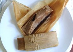 two tamales sitting on top of a white plate