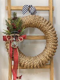 a wooden ladder with a wreath on it