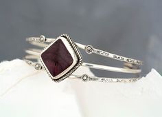 "This bracelet has been handmade using 925 Sterling Silver that has been fused, stamped and lightly oxidized. The setting is a square Purple Spiny Oyster Cabochon that is in a Bezel setting accented with twisted wire. The cuff is 6 1/2\" with a 1 1/4\" gap. This bracelet cannot be resized.  Size Large Introducing our one of a kind Purple Spiny Oyster Sterling Silver Cuff Bracelet.  Spiny Oyster is a beautiful natural stone and comes in 3 colors, Orange, Red and Purple. Their source is the Spiny Oyster Mollusk, a gift from Mother Nature. This is large scale but dainty bracelet that will perk up any outfit. This southwest artisan bracelet is that perfect unique, one of a kind, gift for her you've been searching for. It can also be a fun, surprise stocking stuffer  All purchases arrive in an Purple Spiny Oyster Jewelry, Spiny Oyster Jewelry, Jewelry Purple, Metal Smithing, Vero Beach Fl, Artisan Bracelets, Colors Orange, Dainty Bracelet, Twisted Wire