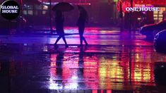 two people walking in the rain with an umbrella