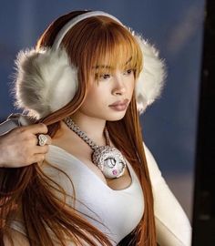 a woman with long red hair wearing headphones