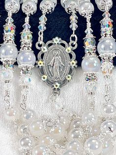 This stunning mystic Quartz rosary design is so shimmering and as beautiful as real bubbles in its specialty finish.  Each bead is satiny smooth and angelic.  The silver centerpiece is the Miraculous Medal of our mother Mary.  I have individually hand turned or wire wrapped this rosary for superior durability and longevity.   It's a full five decade rosary, made up of 8mm genuine Quartz beads for the Ave Maria prayers, and 10mm  beads for the Pater prayers, which are flanked on either end with h Handmade Silver Wedding Rosary, Silver Spiritual Wedding Rosary, Ave Maria Prayer, Rosary Design, Decades Of The Rosary, Silver Centerpiece, Decade Rosary, Mystic Quartz, Catholic Wedding