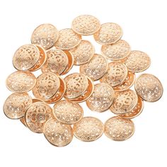 lots of gold colored metal buttons on a white background with no image in the middle