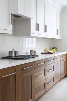 a kitchen with wooden cabinets and white counter tops