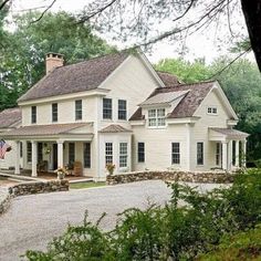 a large white house surrounded by trees and bushes