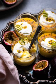 four desserts on a plate with fruit and whipped cream