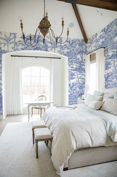 a bedroom with blue and white wall paper