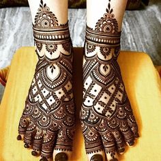 the legs and feet of a woman with henna tattoos