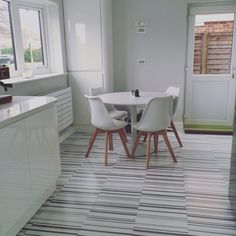 a white table and four chairs in a room