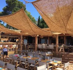 an outdoor dining area with tables and chairs