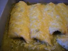 an enchilada in a pan with cheese on top