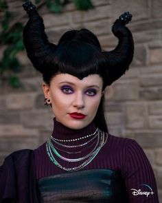 a woman with black hair and horns on her head