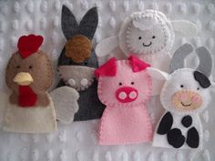 six felt farm animals on a white blanket